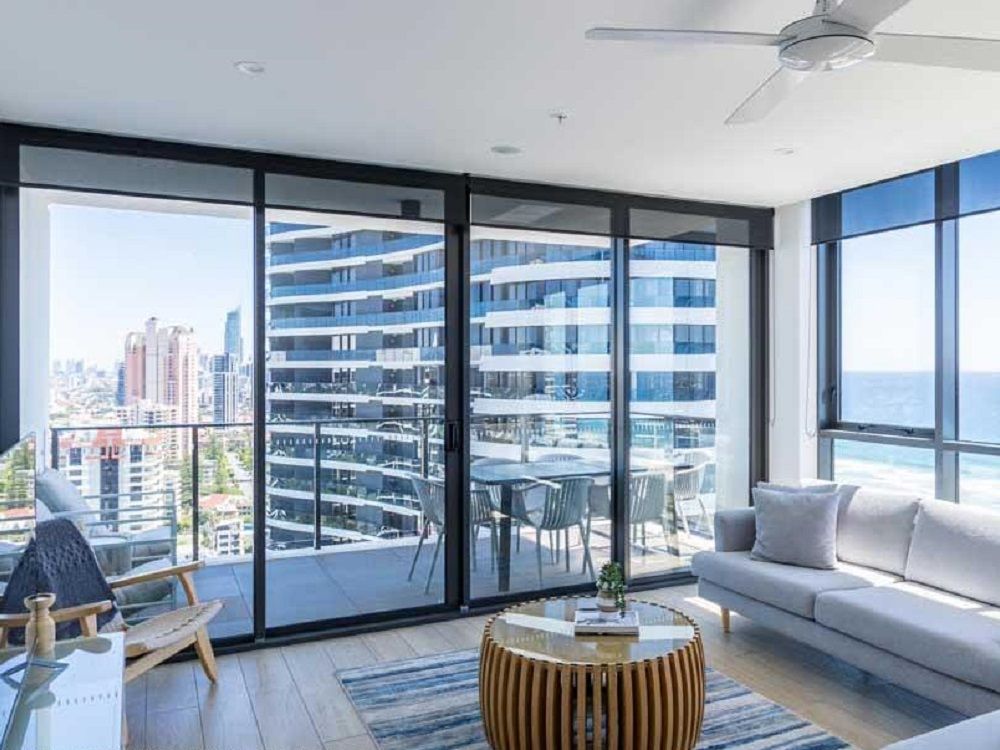 Floor-to-ceiling sliding glass doors opening onto a high-rise apartment balcony at Koko Broadbeach